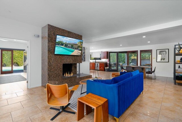 living room with light tile patterned floors and a high end fireplace