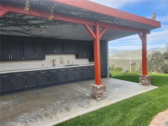 view of patio featuring a mountain view and sink