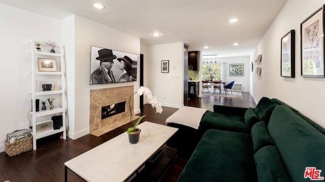 living room featuring a high end fireplace and dark hardwood / wood-style floors