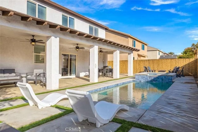 rear view of property with ceiling fan, a swimming pool with hot tub, outdoor lounge area, and a patio