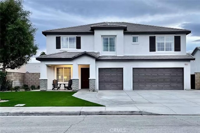 view of front of home with a front yard and a garage