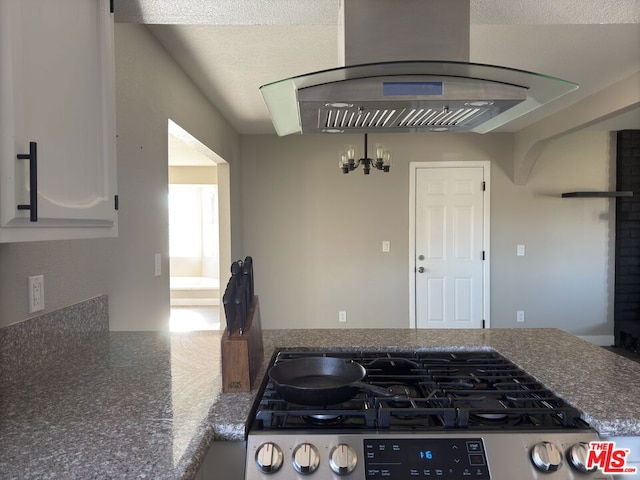 kitchen featuring white cabinets, exhaust hood, and range