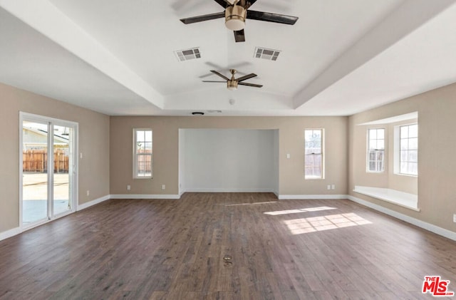 unfurnished living room featuring dark hardwood / wood-style floors, a raised ceiling, and ceiling fan