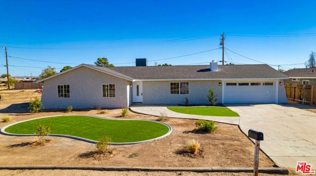 single story home with a garage and a front lawn