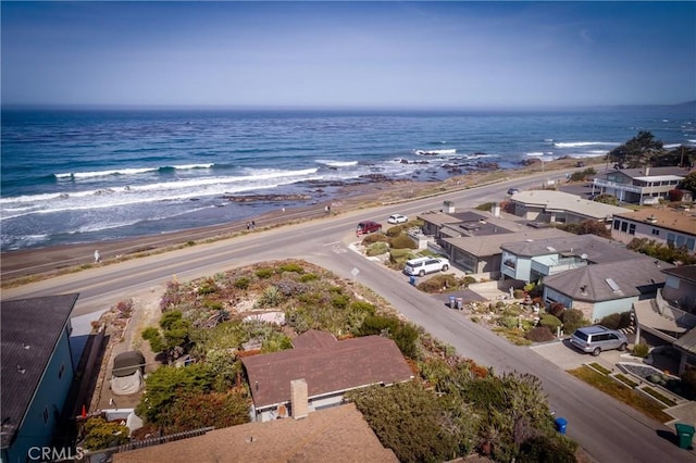 birds eye view of property with a view of the beach and a water view