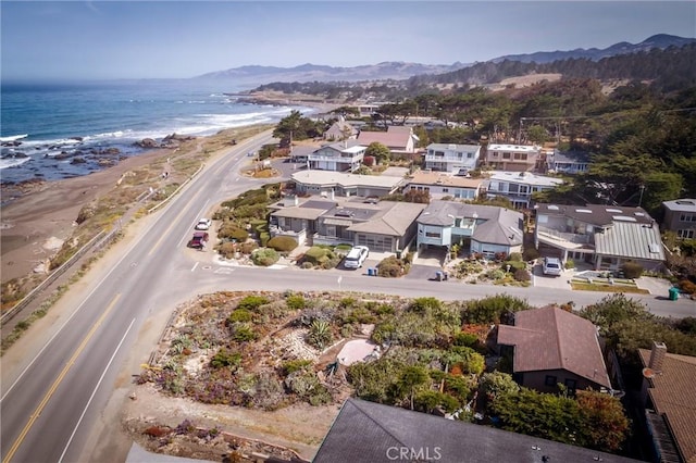 drone / aerial view featuring a water and mountain view