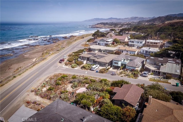 birds eye view of property with a water view and a view of the beach