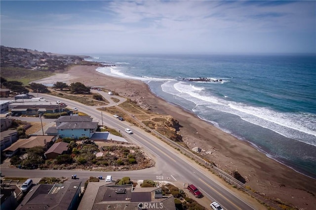 birds eye view of property featuring a water view and a beach view