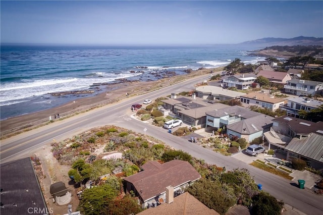 drone / aerial view with a water view and a view of the beach