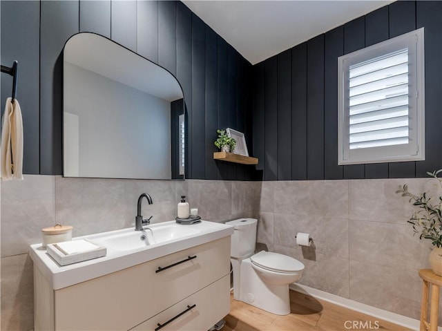 bathroom with vanity, toilet, and wood-type flooring