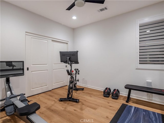 exercise room featuring ceiling fan and hardwood / wood-style floors