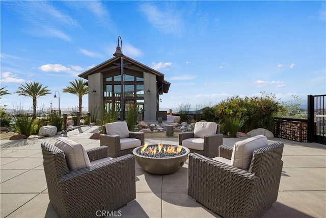 view of patio / terrace with an outdoor living space with a fire pit