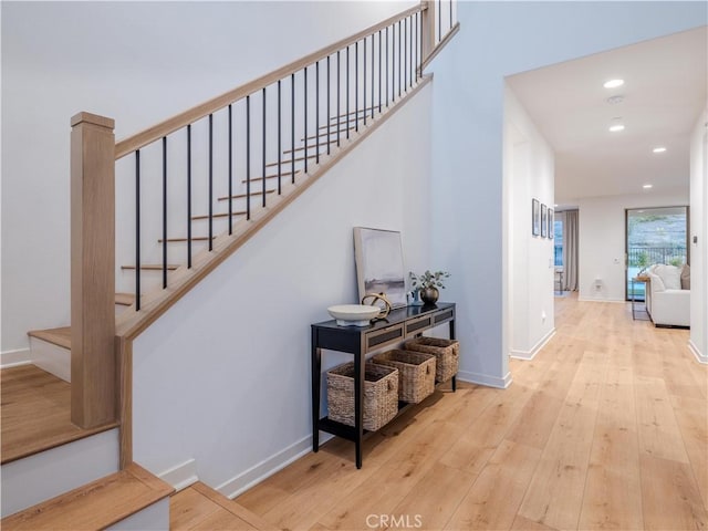 staircase with hardwood / wood-style flooring