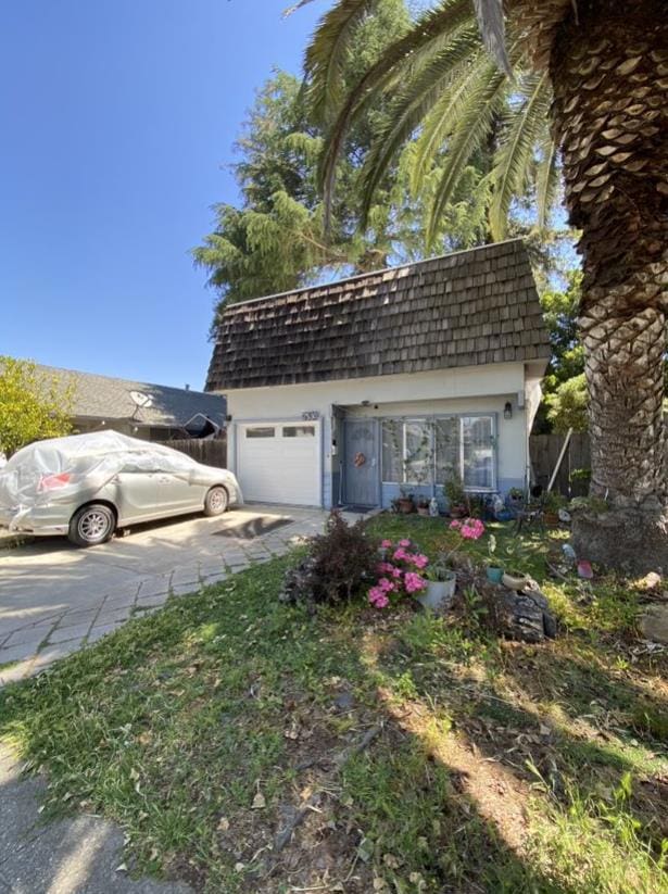 view of front of property featuring a garage and an outdoor structure