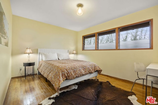 bedroom with wood-type flooring