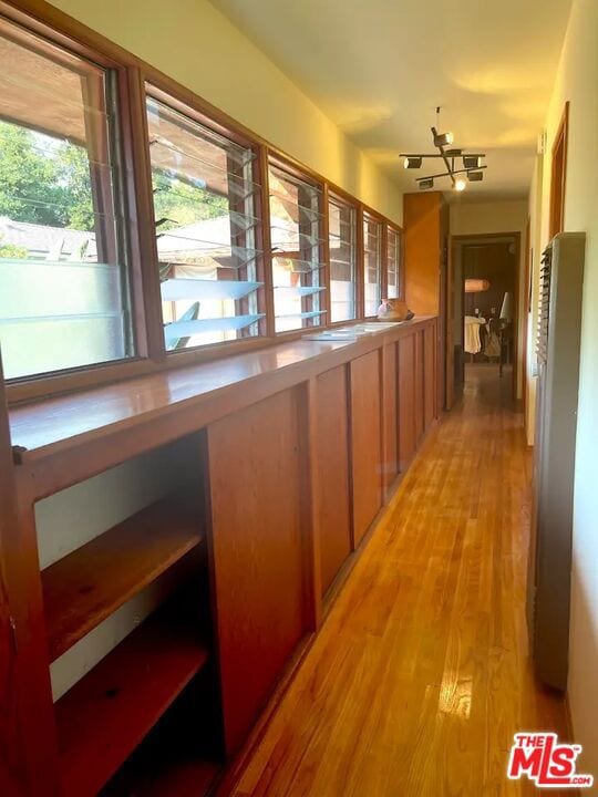 hall featuring a chandelier and light hardwood / wood-style floors