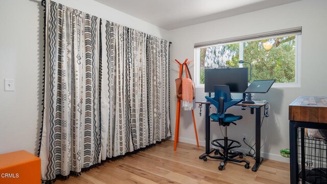 office space with wood-type flooring