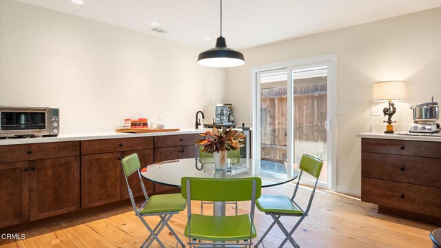 dining area featuring light hardwood / wood-style flooring and sink