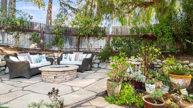 view of patio featuring an outdoor living space with a fire pit