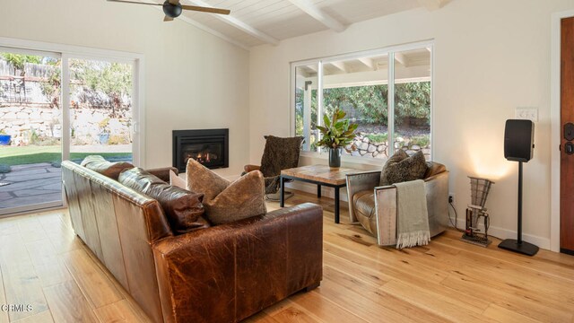 living room featuring ceiling fan, light hardwood / wood-style flooring, lofted ceiling with beams, and wooden ceiling