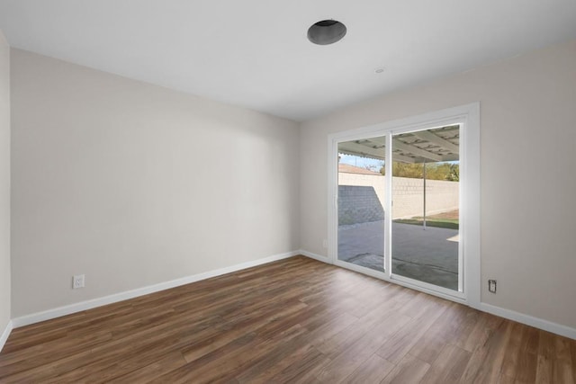 unfurnished room featuring dark hardwood / wood-style flooring