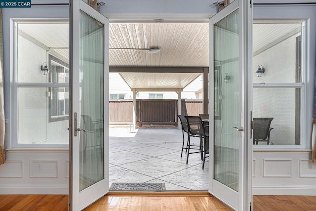 doorway to outside with french doors and light hardwood / wood-style flooring