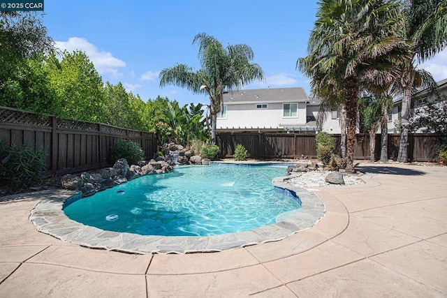 view of pool with pool water feature and a patio area