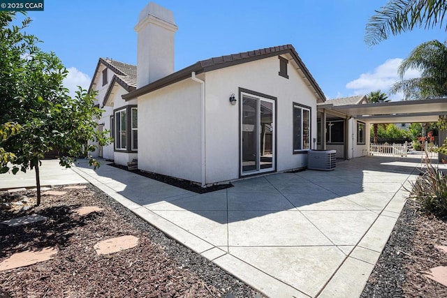 back of house with central air condition unit and a patio