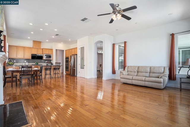 living room featuring ceiling fan and light hardwood / wood-style floors