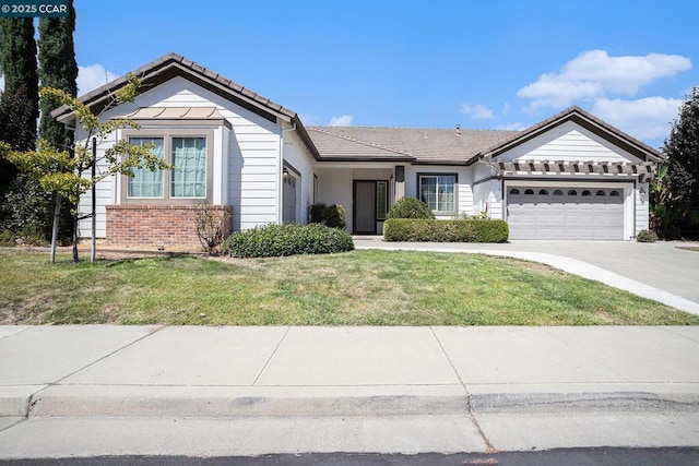 ranch-style home with a garage and a front lawn