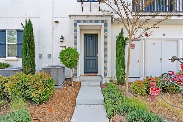 doorway to property featuring cooling unit