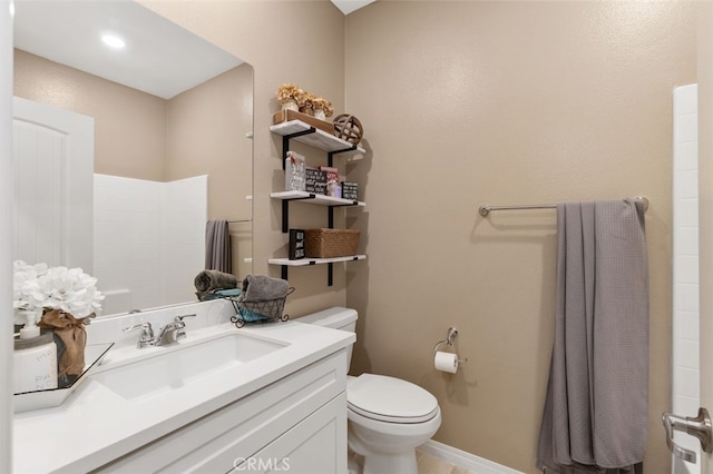 bathroom featuring toilet and vanity