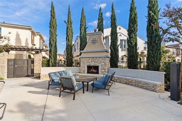 view of patio featuring an outdoor stone fireplace