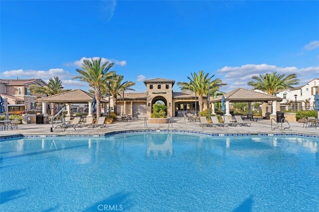 view of swimming pool with a gazebo and a patio