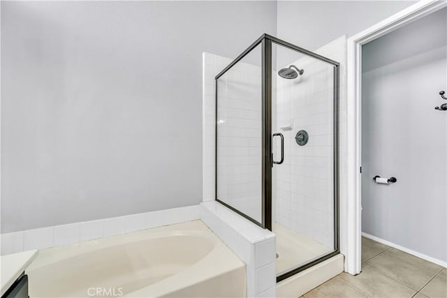 bathroom with separate shower and tub and tile patterned flooring