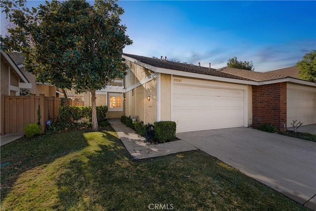 single story home with a front yard and a garage