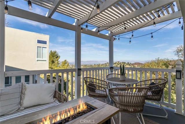 wooden terrace with a pergola and an outdoor fire pit