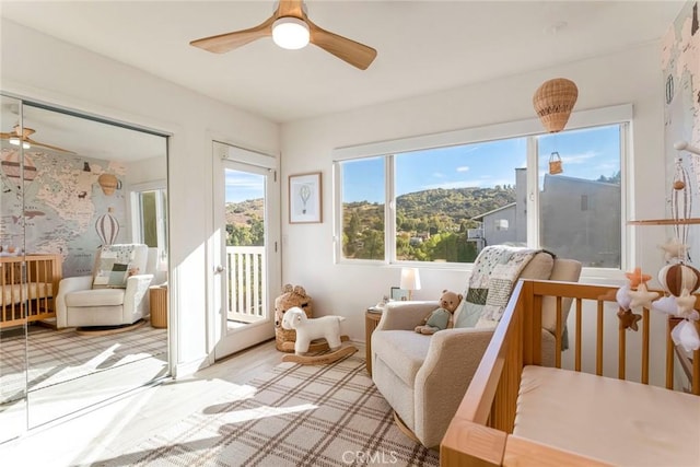 sunroom featuring a mountain view and ceiling fan