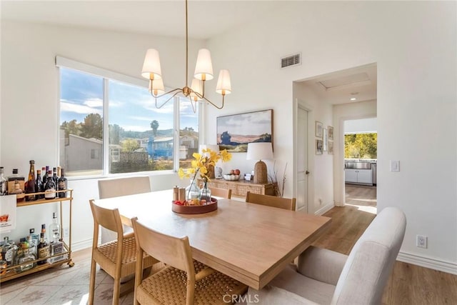 dining room with a chandelier and light hardwood / wood-style floors