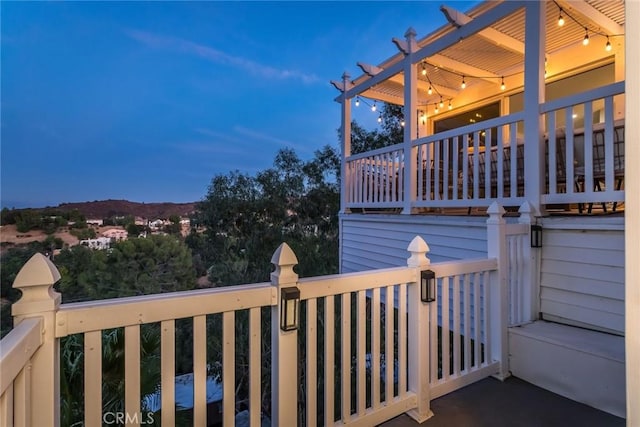 property exterior at dusk featuring a balcony