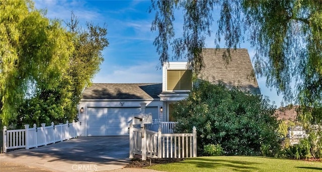 view of front of property featuring a garage and a front lawn