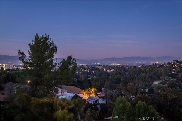 aerial view at dusk featuring a mountain view