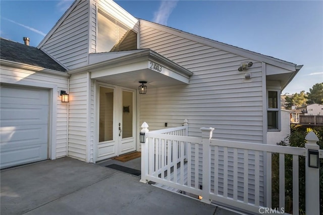 doorway to property with a garage