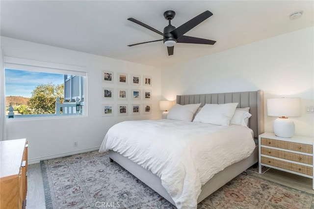 bedroom with ceiling fan and light hardwood / wood-style flooring