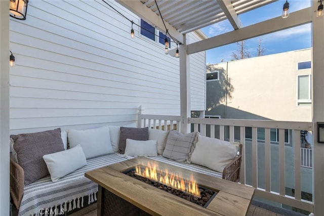 wooden terrace featuring an outdoor fire pit