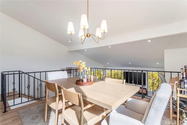 dining area featuring an inviting chandelier, vaulted ceiling with beams, and light hardwood / wood-style floors