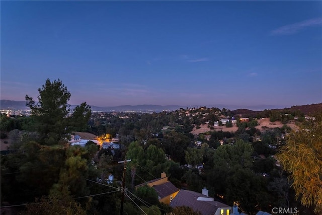 aerial view at dusk featuring a mountain view