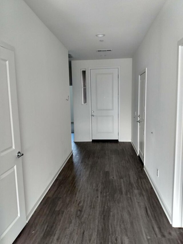 corridor with dark hardwood / wood-style floors