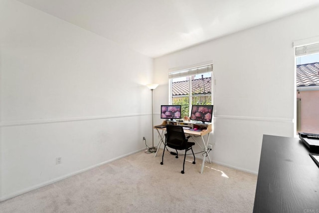 home office featuring light carpet and a healthy amount of sunlight