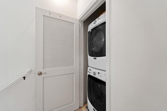 laundry room with stacked washer and dryer